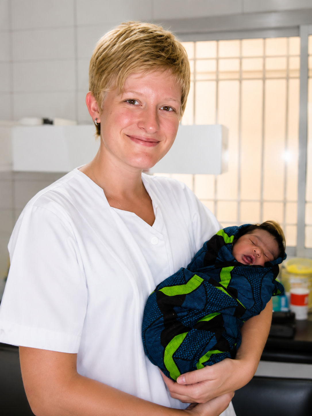 Lynn Vandecauter holding a newborn